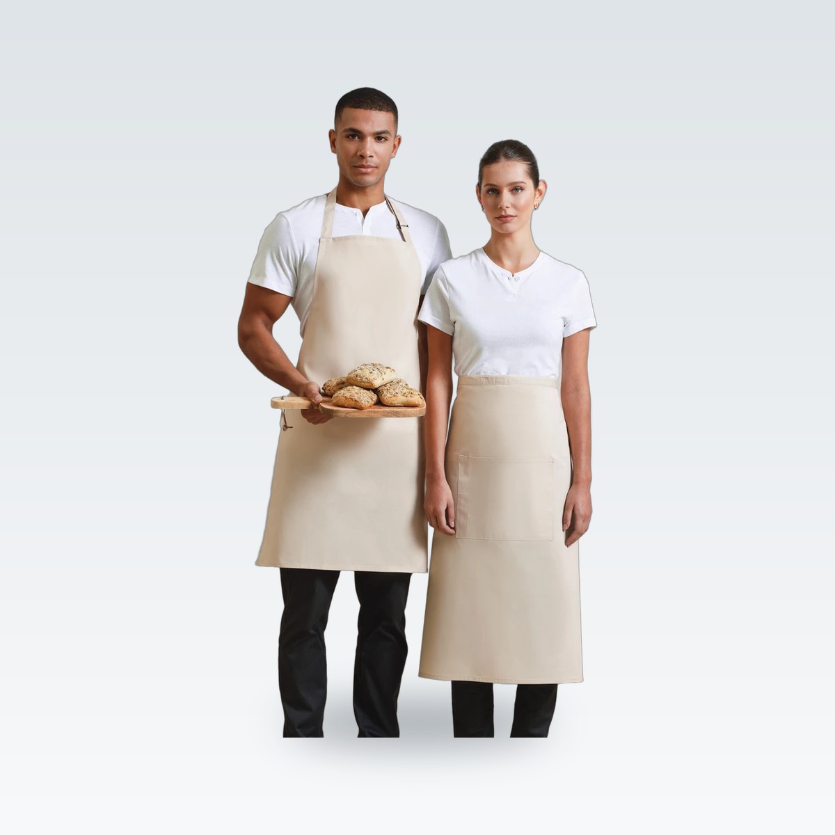 Two staff in natural aprons and white T-shirts